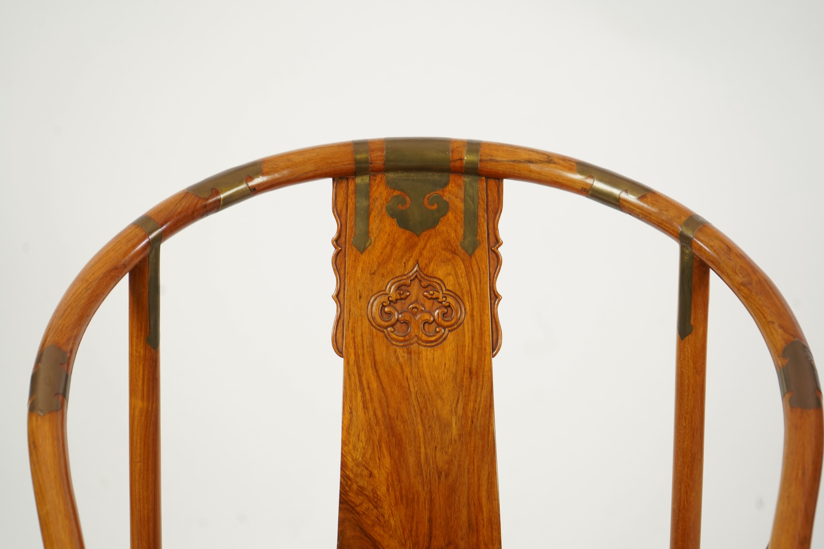 A Chinese huanghuali and brass mounted horseshoe-back armchair, quanyi, late 19th century